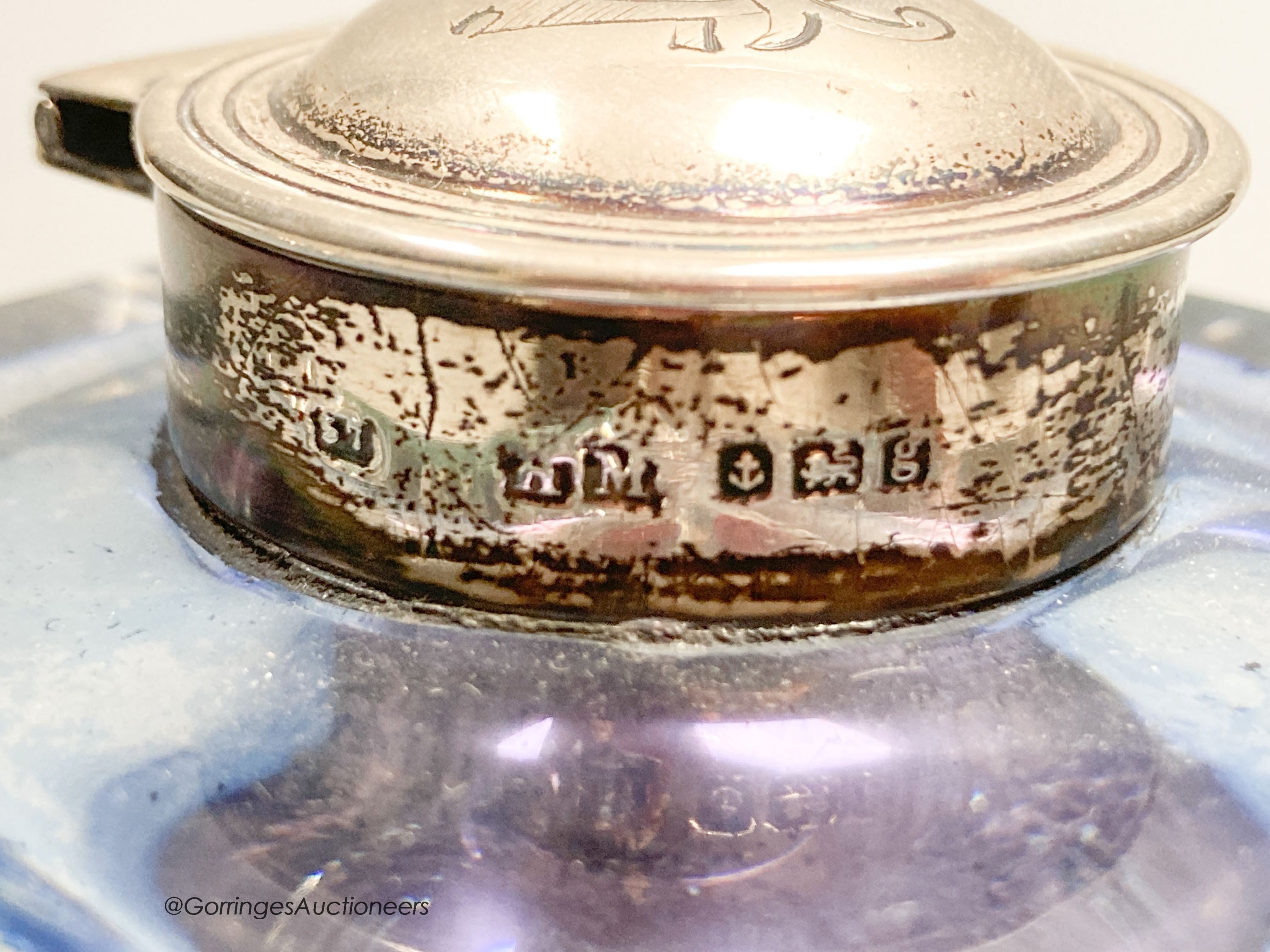 A silver mounted glass inkwell, two silver spoons and a silver Christening set.